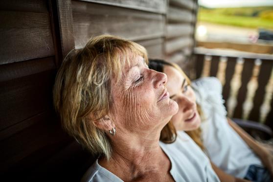 Woman sitting with granddaughter on porch